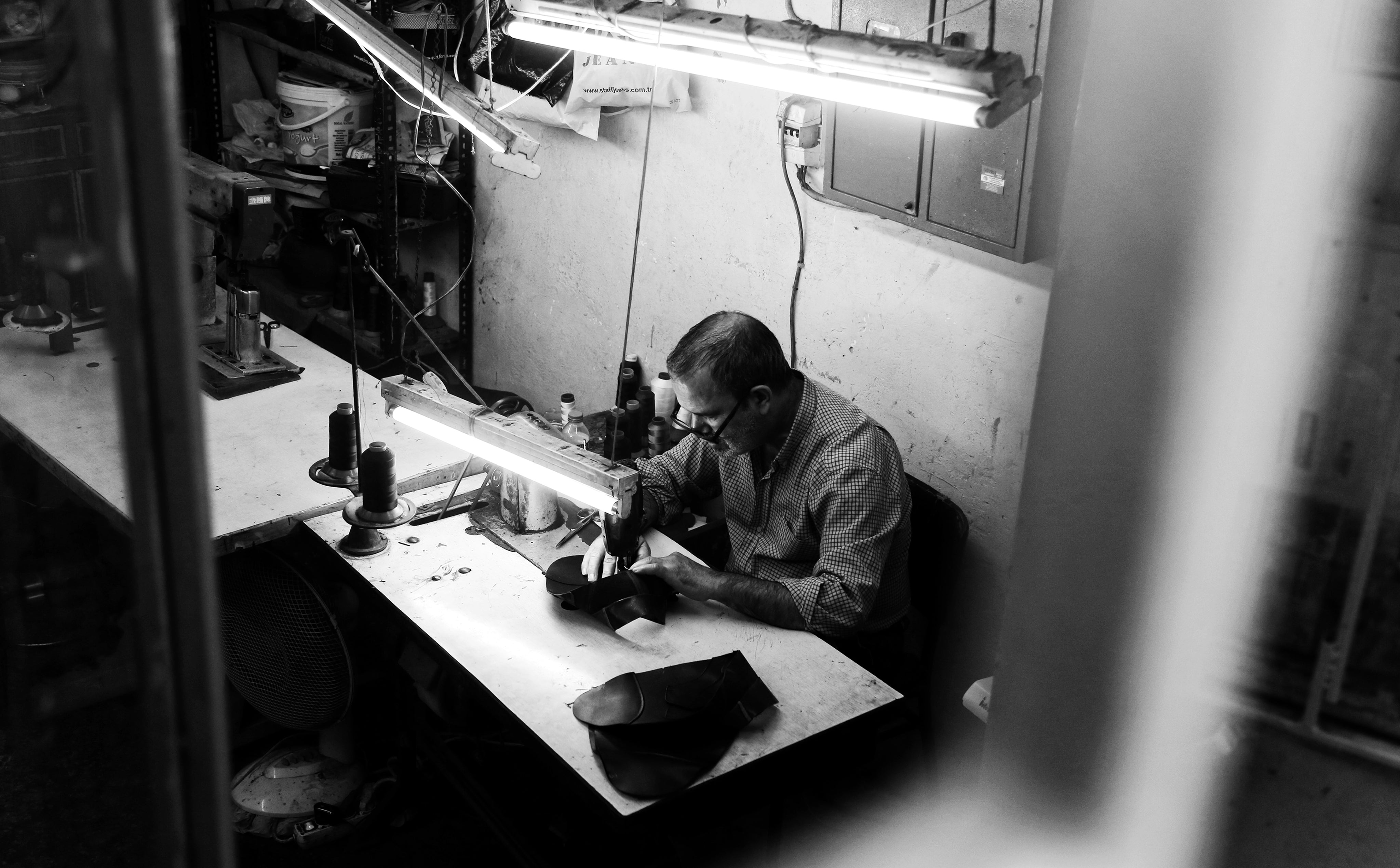 black-and-white-photo-of-a-person-sitting-by-sewing-machine.jpg